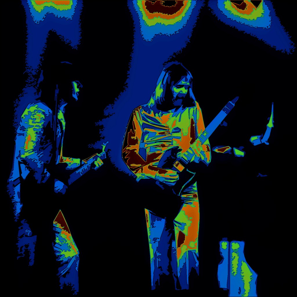FOGHAT 3 FOGHAT ROCKING IN SPOKANE, WA. ON 2-2-77. PHOTO BY BEN UPHAM. MAGICAL MOMENT PHOTOS.